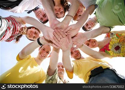 Group of nine friends keep for hands