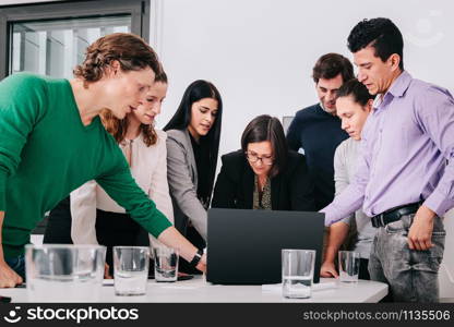 Group of office workers at a meeting around the boss