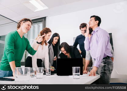 Group of office workers at a meeting around the boss