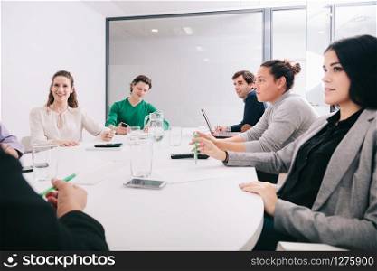 Group of office workers at a meeting around the boss