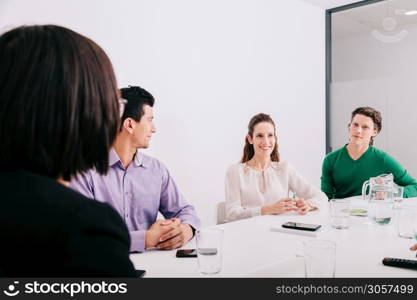 Group of office workers at a meeting around the boss
