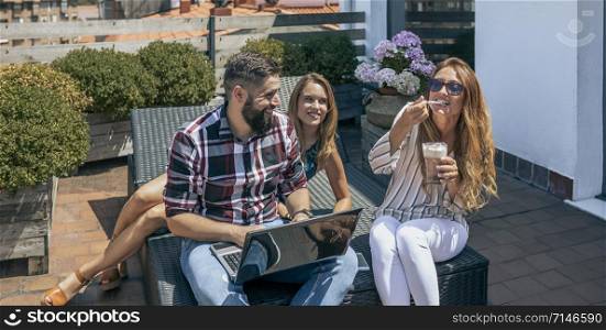 Group of office workers working and resting on the terrace of the officce