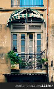 Group of old wooden window and antique door at facade of old house at Ho Chi Minh city, Vietnam