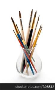 Group of paintbrushes in a glass jar. Assorted paintbrushes