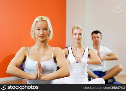 Group of people doing yoga exercise