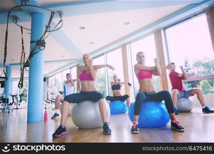 group of people exercise with balls on yoga class in fitness gym. group of people exercise with balls on yoga class