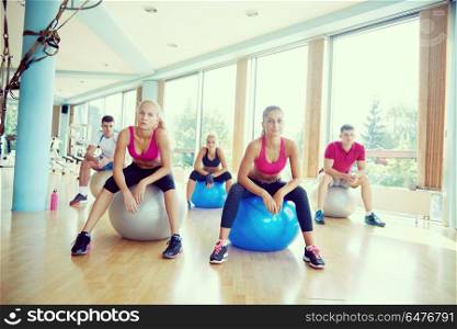 group of people exercise with balls on yoga class in fitness gym. group of people exercise with balls on yoga class