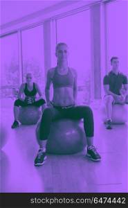 group of people exercise with balls on yoga class in fitness gym duo tone. group of people exercise with balls on yoga class
