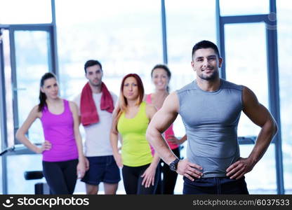 Group of people exercising at the gym and stretching