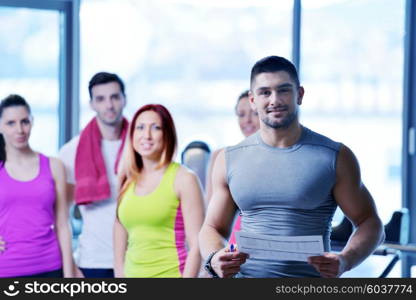 Group of people exercising at the gym and stretching