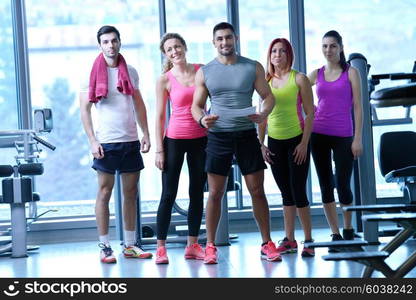 Group of people exercising at the gym and stretching