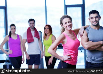 Group of people exercising at the gym and stretching