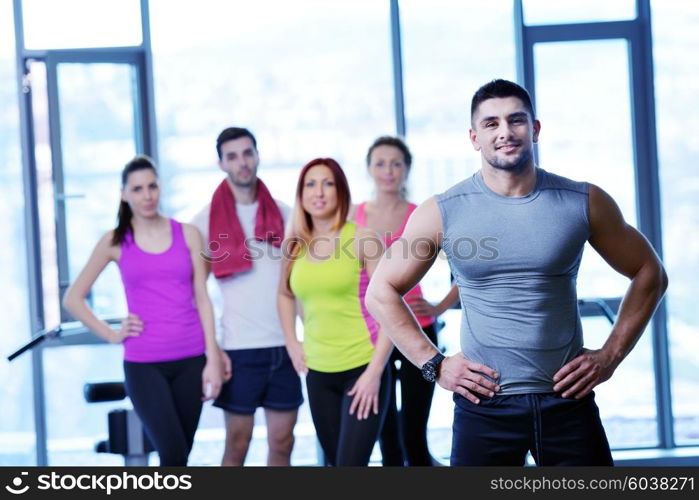 Group of people exercising at the gym and stretching