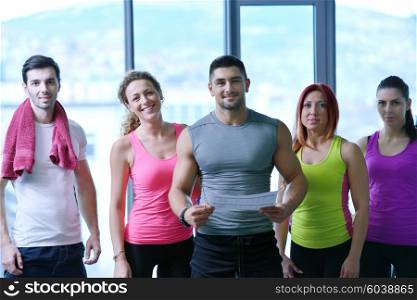 Group of people exercising at the gym and stretching