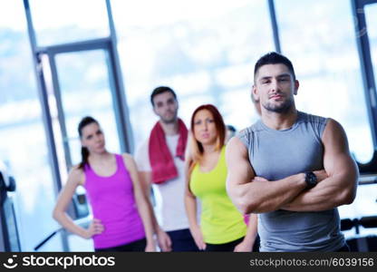 Group of people exercising at the gym and stretching