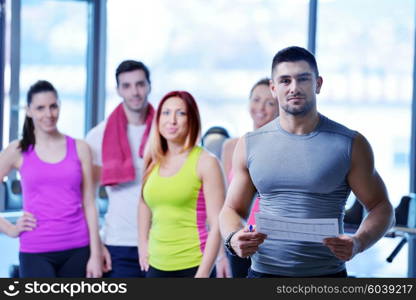 Group of people exercising at the gym and stretching