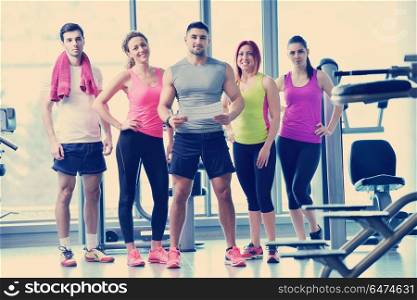 Group of people exercising at the gym and stretching. Group of people exercising at the gym