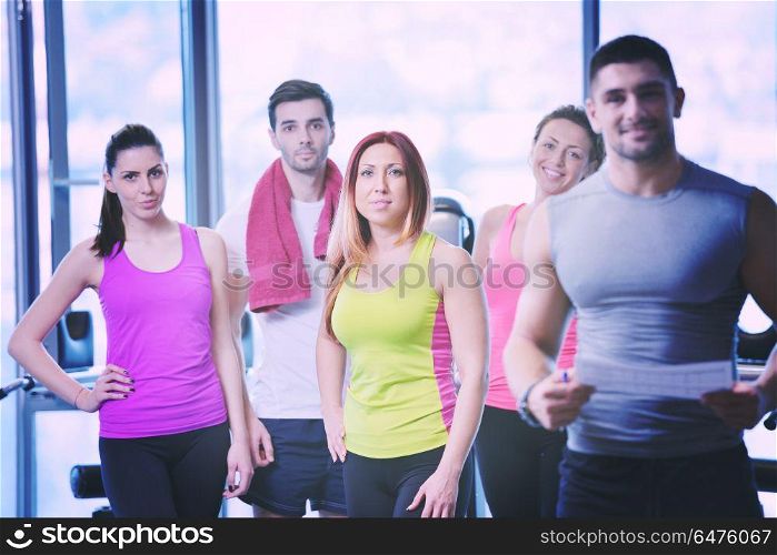 Group of people exercising at the gym and stretching. Group of people exercising at the gym