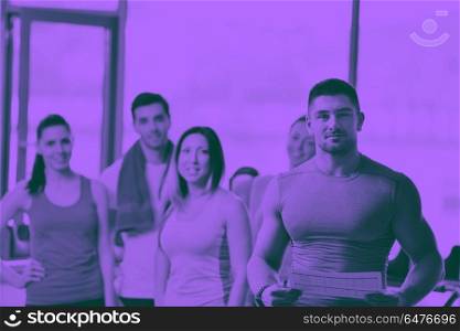 Group of people exercising at the gym. Group of people exercising at the gym and stretching duo tone