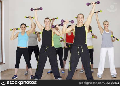 Group Of People Exercising In Dance Studio With Weights