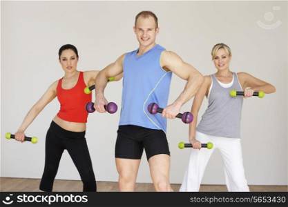 Group Of People Exercising In Dance Studio With Weights