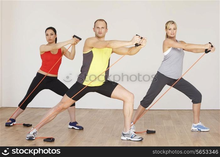 Group Of People Exercising In Gym