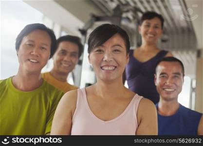 Group of people exercising in the gym, portrait