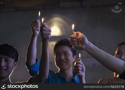 Group of people holding cigarette lighters at a concert