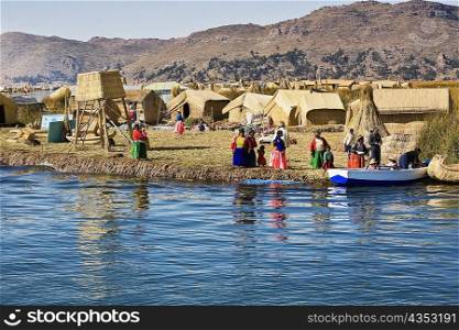 Group of people in a village, Lake Titicaca, Uros Floating Islands, Puno, Peru