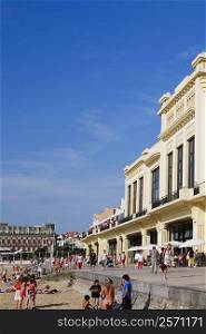 Group of people in front of a hotel, Casino Municipal, Hotel Du Palais, Grande Plage, Biarritz, France