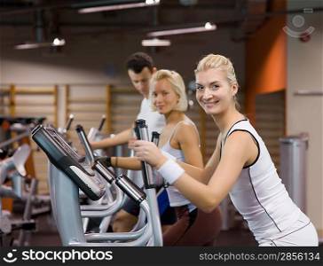 Group of people jogging in a gym