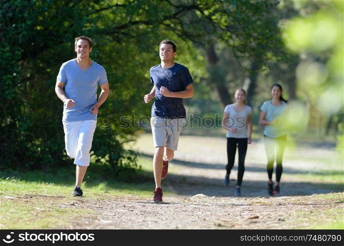 group of people jogging in the park
