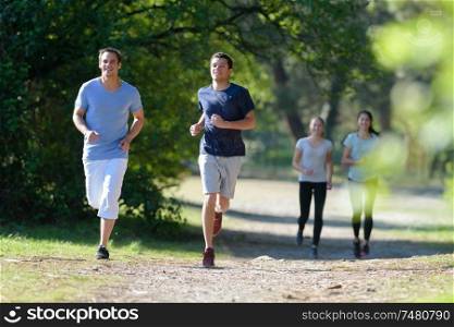 group of people jogging in the park