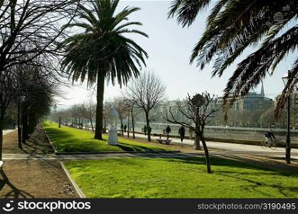 Group of people on the walkway by the river, Spain