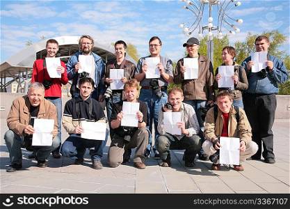Group of people photographers with sheets of paper