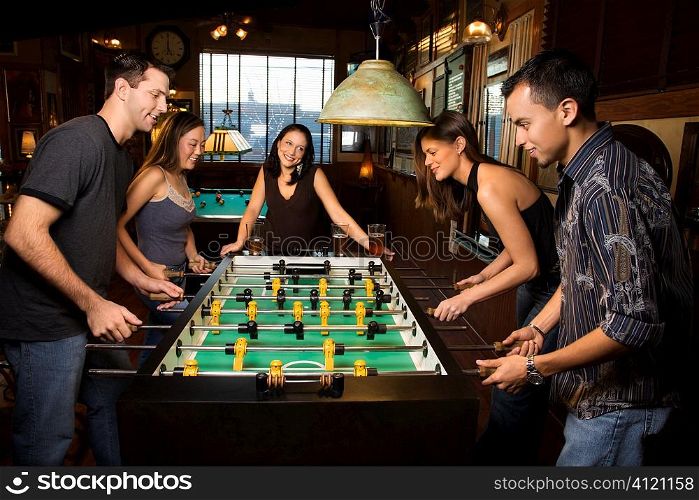 Group of People Playing Foosball