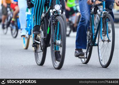 Group of people riding by bicycles on the road