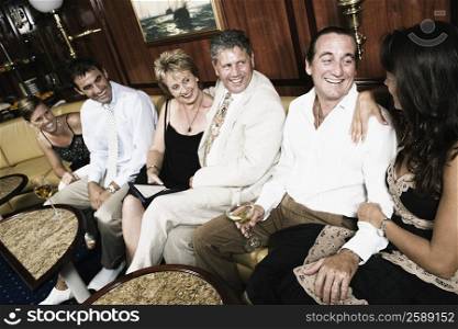 Group of people sitting on a couch and smiling in a sailing ship