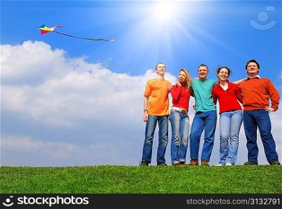 Group of people smiling against blue sky