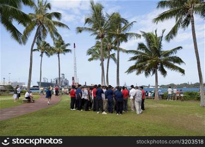 Group of people standing in a park, Pearl Harbor, Honolulu, Oahu, Hawaii Islands, USA