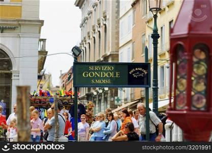 Group of people standing near a signboard, Venice, Italy