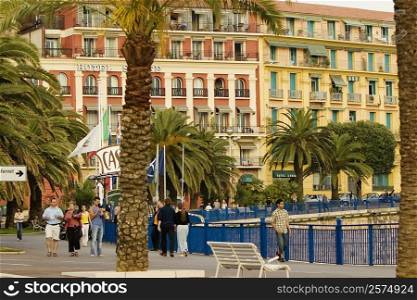 Group of people walking in front of a hotel, Quai Des Etats- Unis, Nice, Provence-Alpes-Cote D&acute;Azur, France