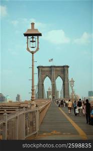 Group of people walking on a bridge, Brooklyn Bridge, New York City, New York State, USA