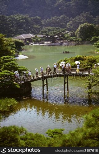 Group of people walking on a bridge, Ritsurin Garden, Takamatsu, Shikoku, Japan