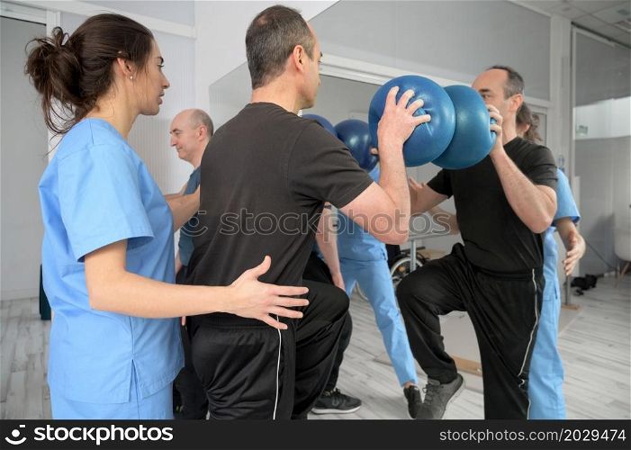Group of People with disability exercising at rehabilitation clinic. High quality photo. Group of People with disability exercising at rehabilitation clinic.