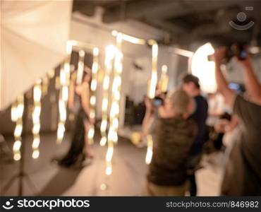 Group of photographer taking photo of model in studio. Class training of photography and lighting.