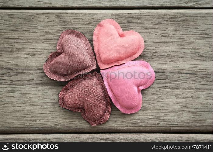 Group of pink tone hearts handmade crafts from silk cloth place on wood background, love and valentine&rsquo;s day symbol