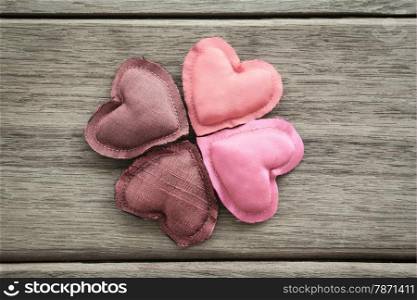 Group of pink tone hearts handmade crafts from silk cloth place on wood background, love and valentine&rsquo;s day symbol