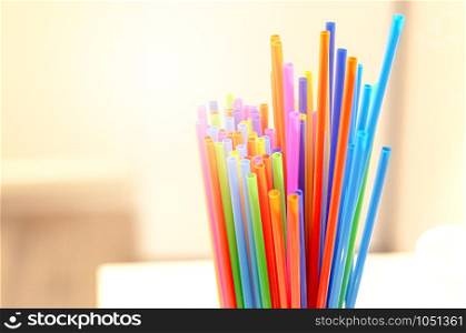 group of plastic straws of various colors Global warming and plastic pollution. Environmental issues. Party and refreshment.