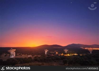 Group of radio telescopes at sunset